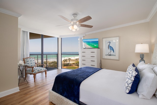 114 Main Sail Dr Unit 137, Miramar Beach, FL 32550 - bedroom with ornamental molding, a wall of windows, light wood-type flooring, access to exterior, and baseboards