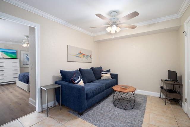 living room featuring ceiling fan, tile patterned floors, and ornamental molding