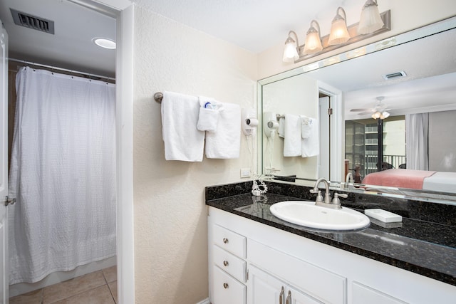 114 Main Sail Dr Unit 137, Miramar Beach, FL 32550 - ensuite bathroom with a textured wall, vanity, ceiling fan, tile patterned floors, and curtained shower