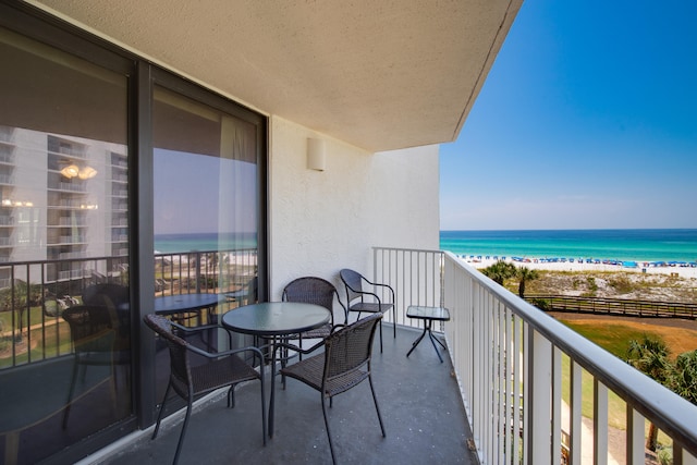 balcony featuring a water view and a view of the beach