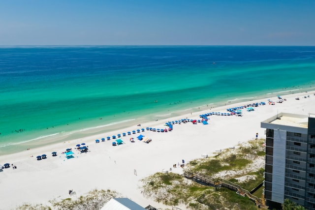 birds eye view of property with a water view and a view of the beach