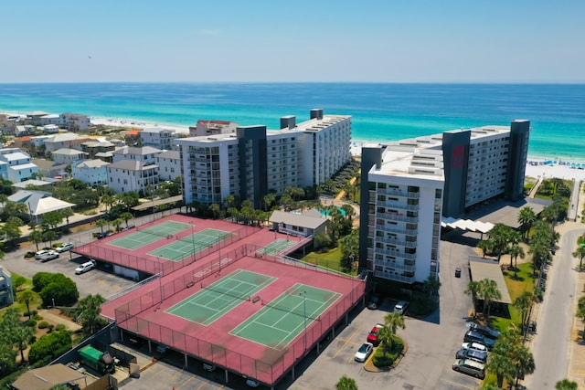 drone / aerial view featuring a water view and a beach view