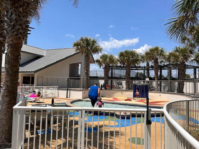 view of pool featuring a jacuzzi and a patio