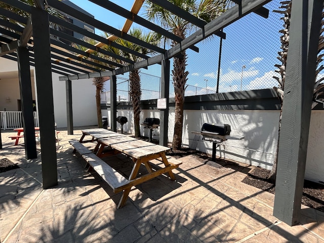 view of patio with a pergola and area for grilling