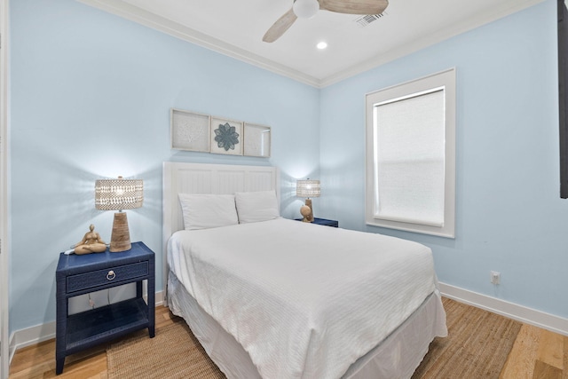 bedroom with light wood-type flooring, ceiling fan, and crown molding