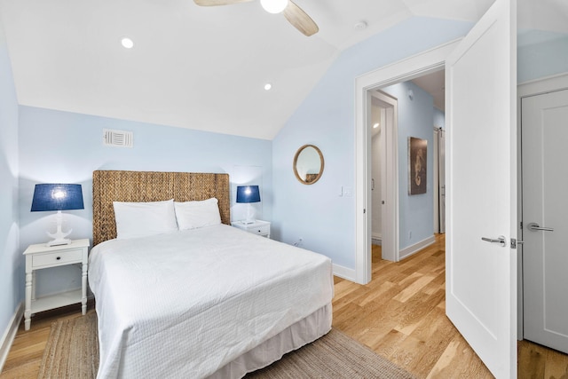 bedroom with ceiling fan, lofted ceiling, and light hardwood / wood-style floors