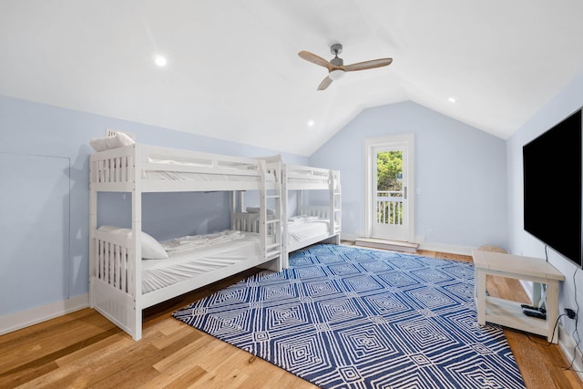 bedroom with ceiling fan, access to exterior, lofted ceiling, and hardwood / wood-style floors