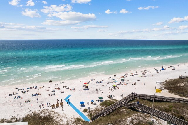 bird's eye view featuring a water view and a beach view