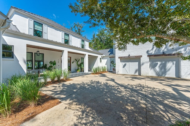 view of front of home featuring a porch and a garage