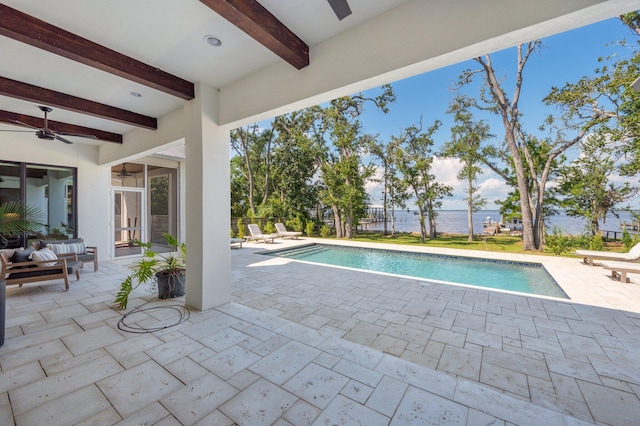 view of swimming pool featuring a patio and ceiling fan