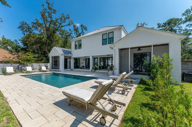 view of swimming pool featuring ceiling fan and a patio area