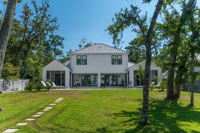 rear view of house with a yard