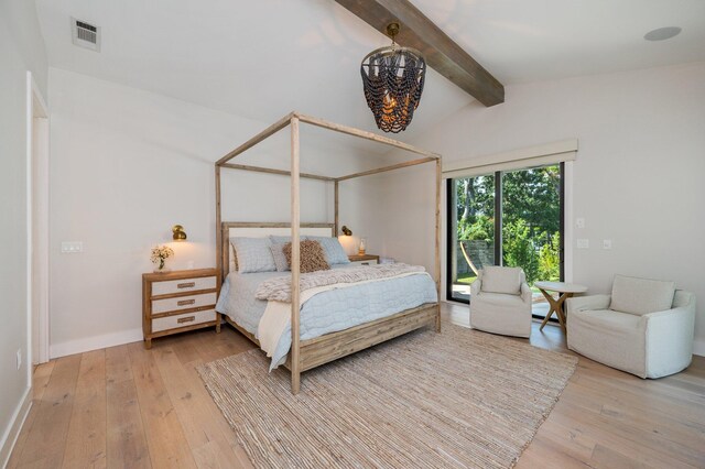 bedroom featuring vaulted ceiling with beams and hardwood / wood-style flooring