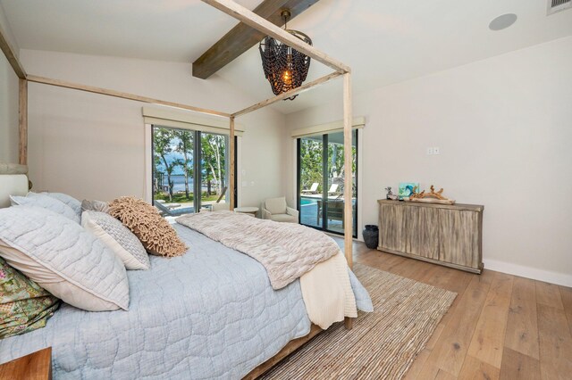 bedroom featuring light hardwood / wood-style flooring, vaulted ceiling with beams, and access to exterior