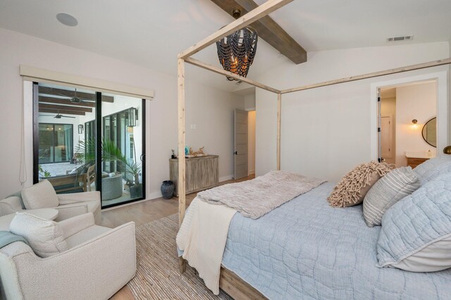 bedroom featuring light hardwood / wood-style flooring, lofted ceiling with beams, and access to exterior