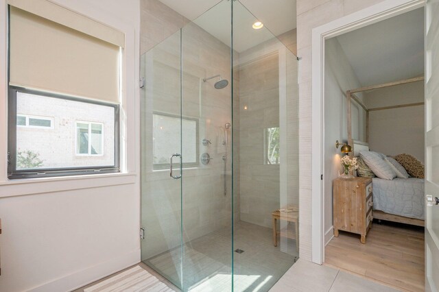 bathroom with wood-type flooring and walk in shower