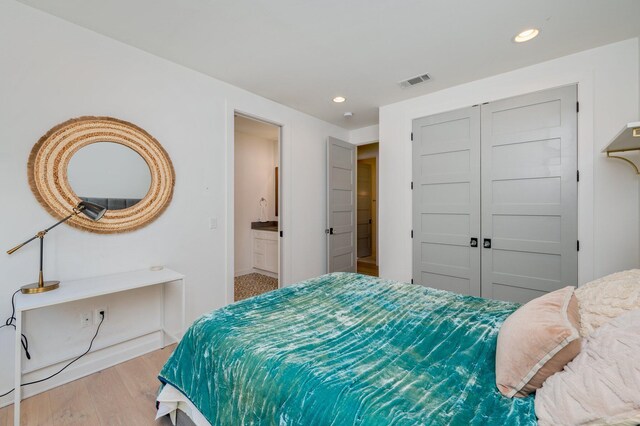 bedroom featuring a closet and light hardwood / wood-style floors