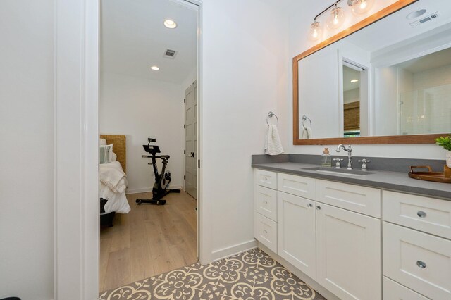 bathroom with vanity and hardwood / wood-style floors