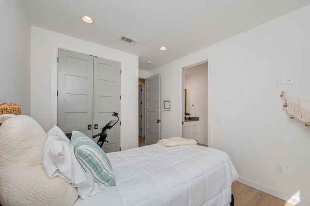 bedroom featuring light wood-type flooring and a closet