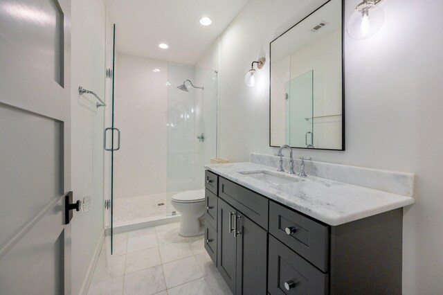 bathroom with tile patterned flooring, walk in shower, vanity, and toilet