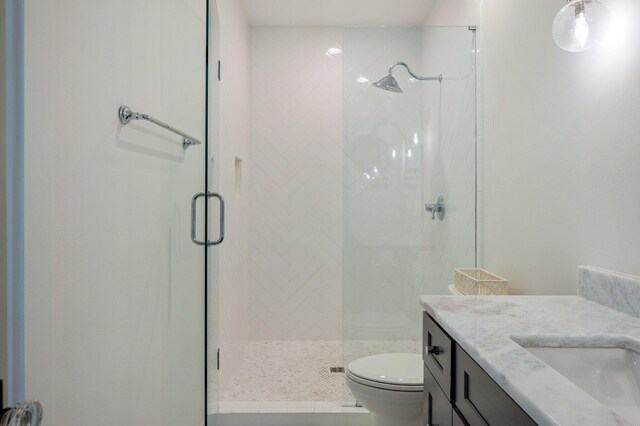 bathroom with vanity, toilet, and an enclosed shower