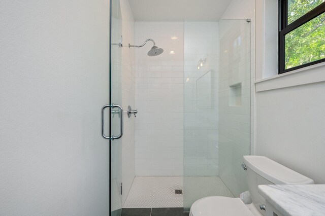 bathroom with walk in shower, toilet, and tile patterned floors