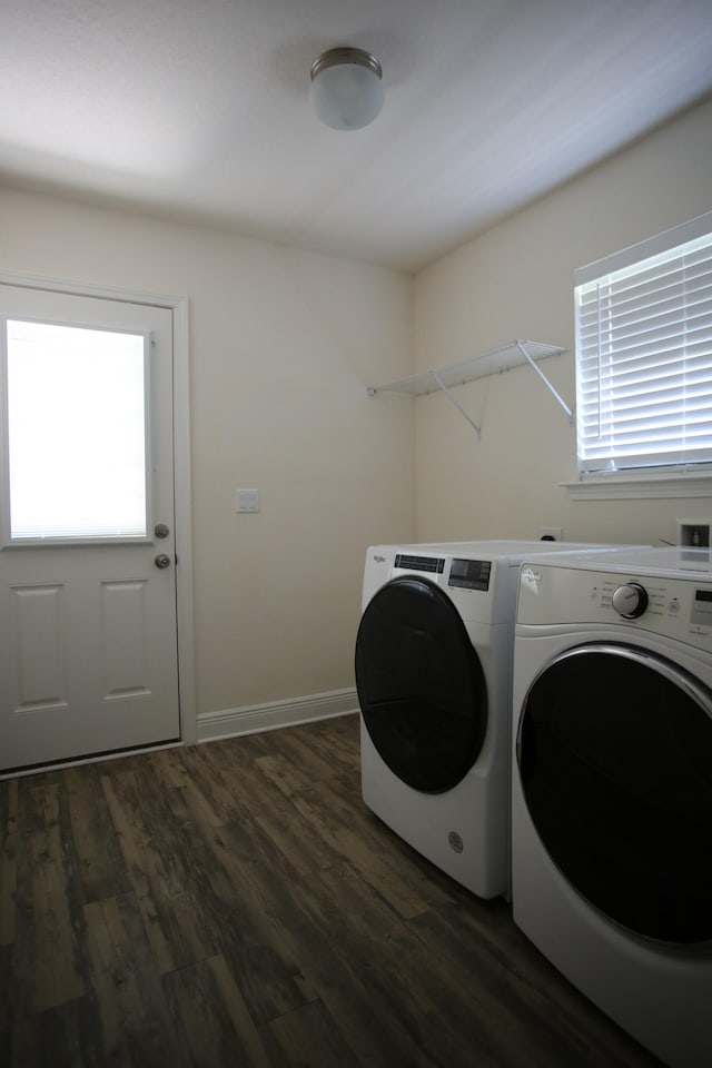 laundry area with dark hardwood / wood-style floors, separate washer and dryer, and plenty of natural light