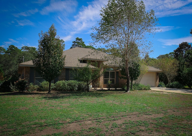 view of front of home with a garage and a front yard