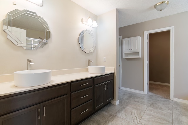 bathroom with vanity and a textured ceiling