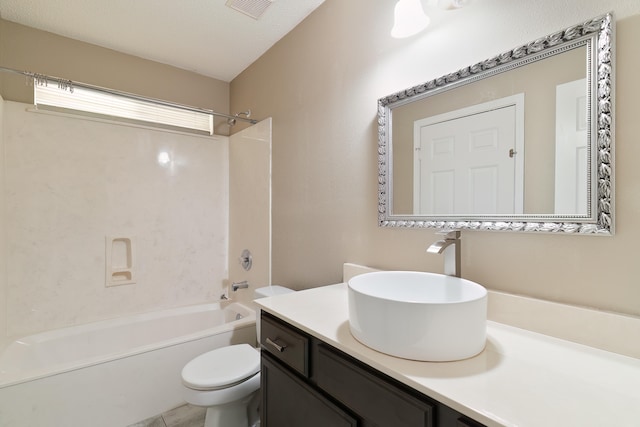 full bathroom featuring toilet, vanity, a textured ceiling, and bathing tub / shower combination