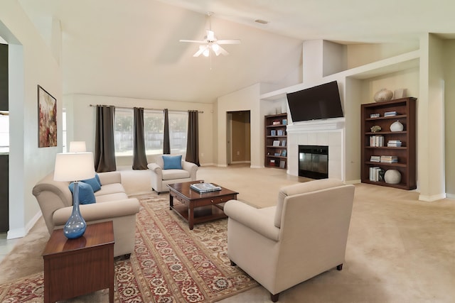 carpeted living room with a fireplace, ceiling fan, and high vaulted ceiling