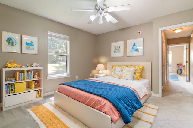 bedroom featuring light carpet and ceiling fan