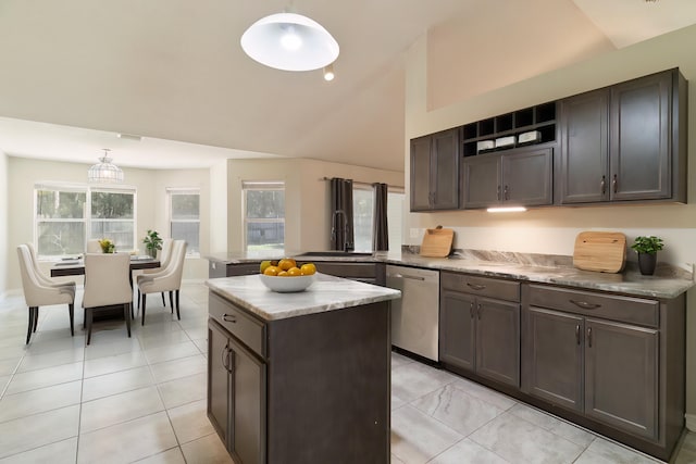 kitchen featuring pendant lighting, a wealth of natural light, lofted ceiling, and stainless steel dishwasher