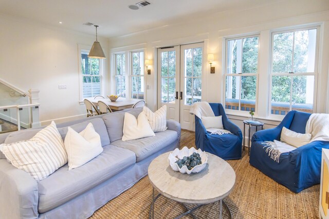 living room featuring light hardwood / wood-style floors, french doors, and a wealth of natural light