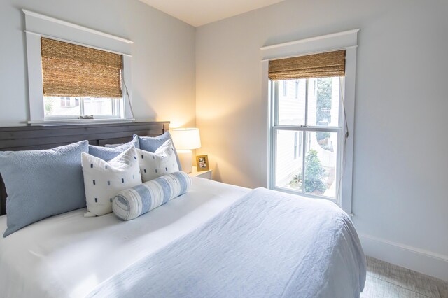 carpeted bedroom featuring multiple windows