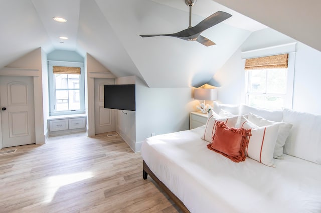 bedroom with light hardwood / wood-style flooring, vaulted ceiling, and ceiling fan