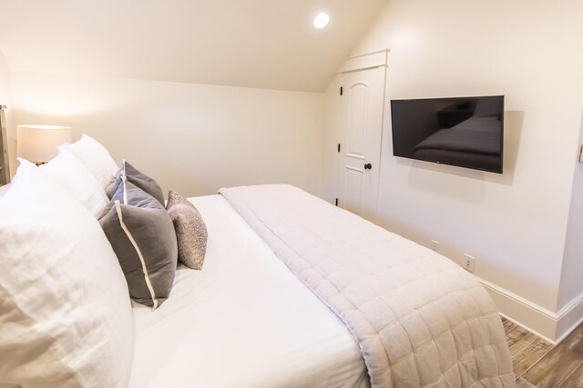 bedroom featuring vaulted ceiling and hardwood / wood-style floors