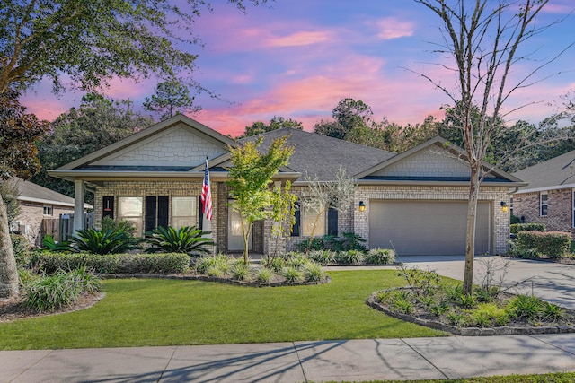 craftsman house featuring a garage and a yard