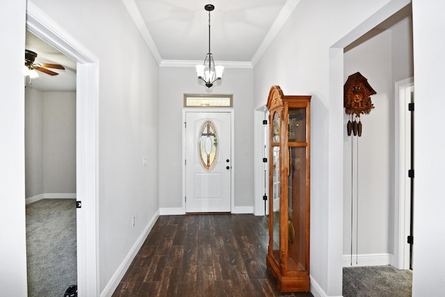 entrance foyer featuring ceiling fan with notable chandelier, crown molding, and dark hardwood / wood-style flooring