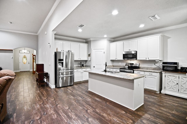 kitchen with white cabinets, an island with sink, appliances with stainless steel finishes, and dark wood-type flooring