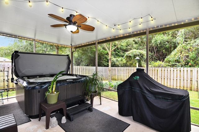 view of patio / terrace featuring ceiling fan and a hot tub