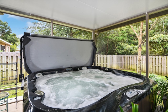 sunroom with a hot tub