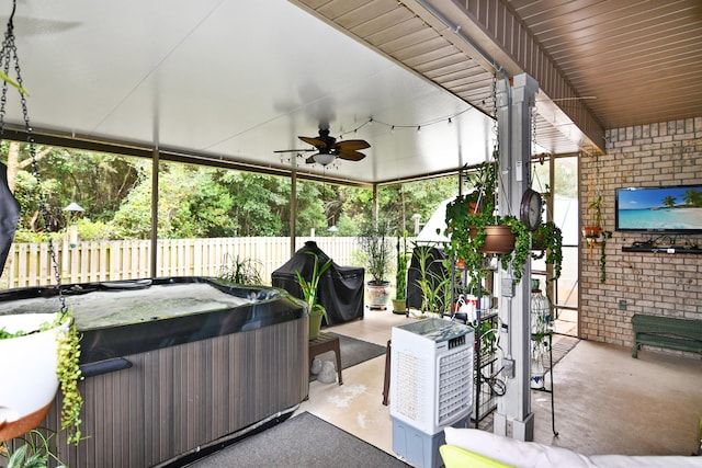 unfurnished sunroom featuring a jacuzzi and ceiling fan