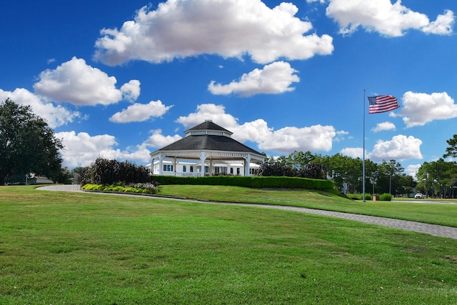 surrounding community with a lawn and a gazebo