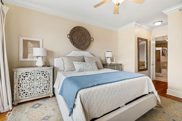 bedroom featuring ornamental molding, hardwood / wood-style floors, ceiling fan, and ensuite bath