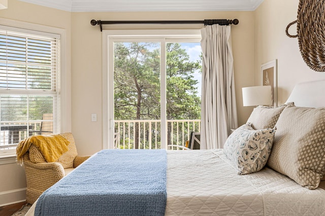 bedroom featuring ornamental molding, multiple windows, hardwood / wood-style flooring, and access to outside