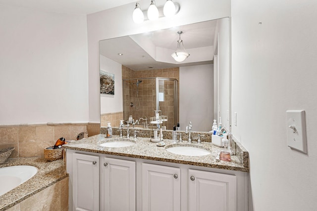 bathroom with tile walls, vanity, and separate shower and tub