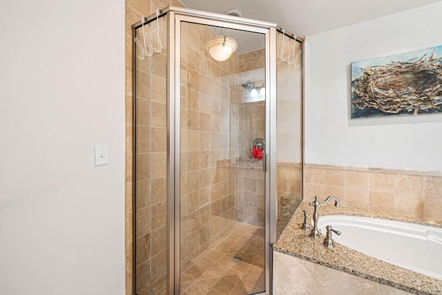 bathroom featuring separate shower and tub