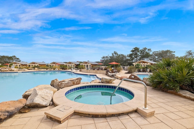 view of pool featuring an in ground hot tub and a patio area