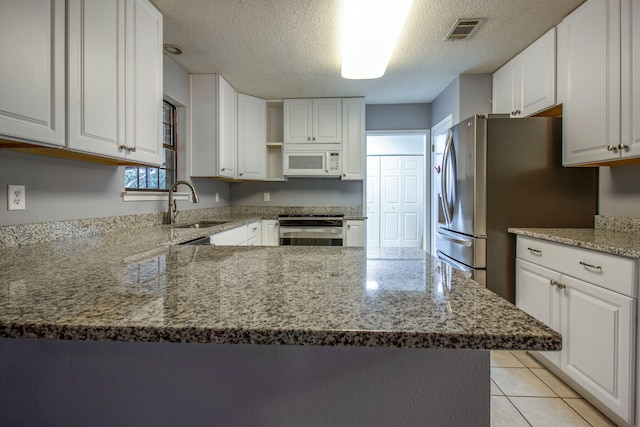 kitchen featuring stainless steel appliances and white cabinetry